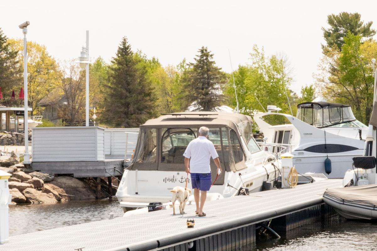 Man and his dog walking on the dock at South Bay Cove Marina